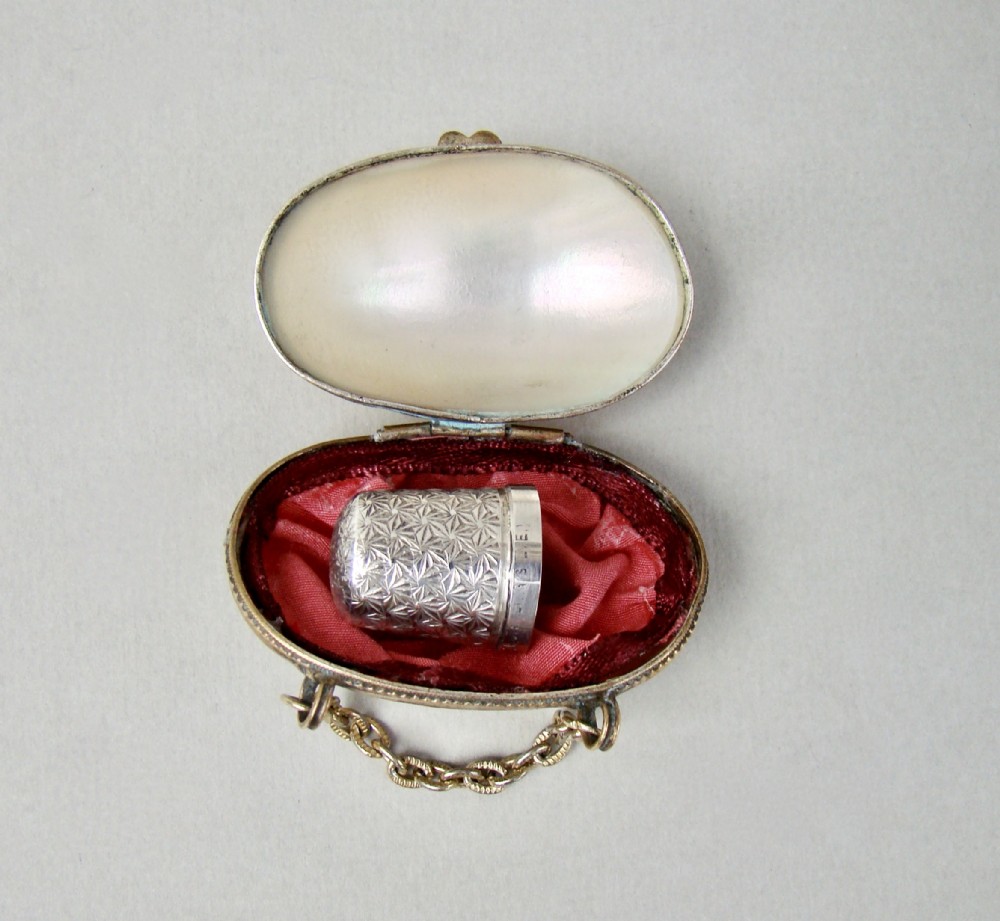 DELIGHTFUL STERLING SILVER THIMBLE IN FRENCH MOTHER OF PEARL CHATELAINE THIMBLE CASE, CIRCA 1890

