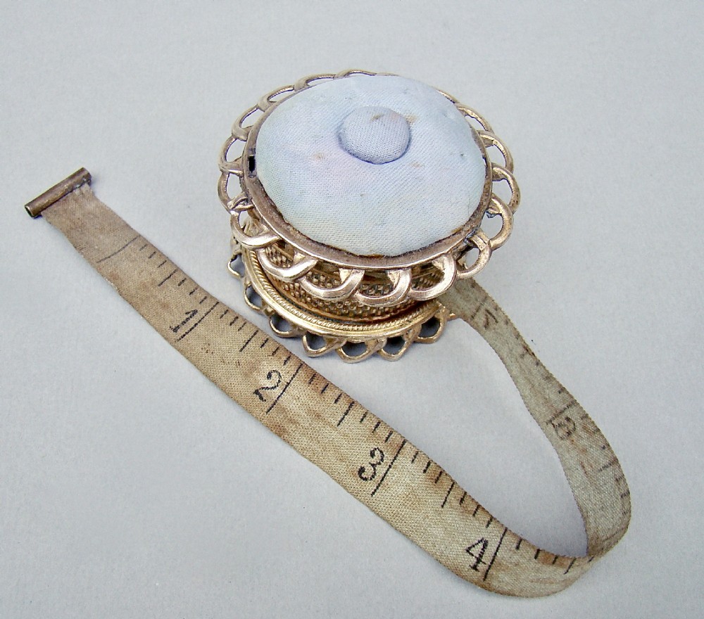 UNUSUAL MID-VICTORIAN ORMULU NOVELTY TAPE MEASURE & PIN CUSHION,  CIRCA 1860