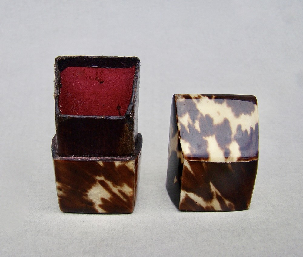 An early Victorian tortoiseshell needle box with a slanted top and mottled brown and cream pattern. View VI