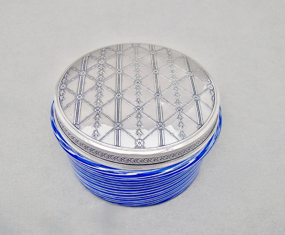 An oval blue and white spiralled glass vanity jar topped with a detailed engraved silver lid. View II