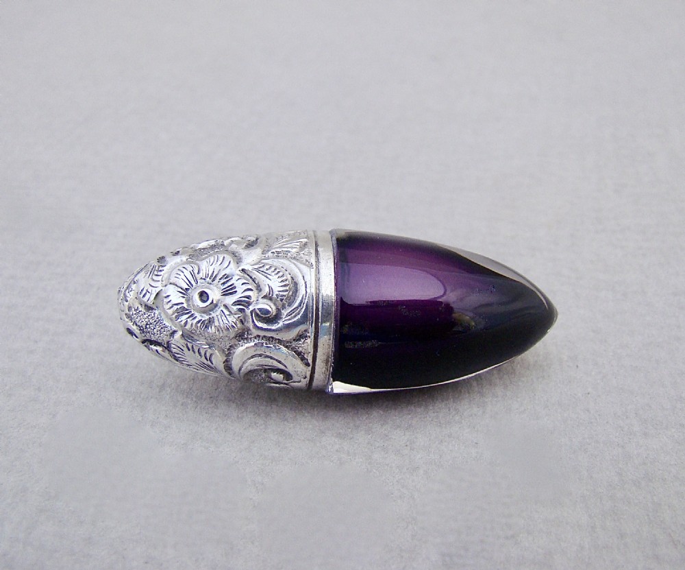 RARE VICTORIAN SILVER AND AMETHYST GLASS BULLET SHAPED SCENT BOTTLE, CIRCA 1890
