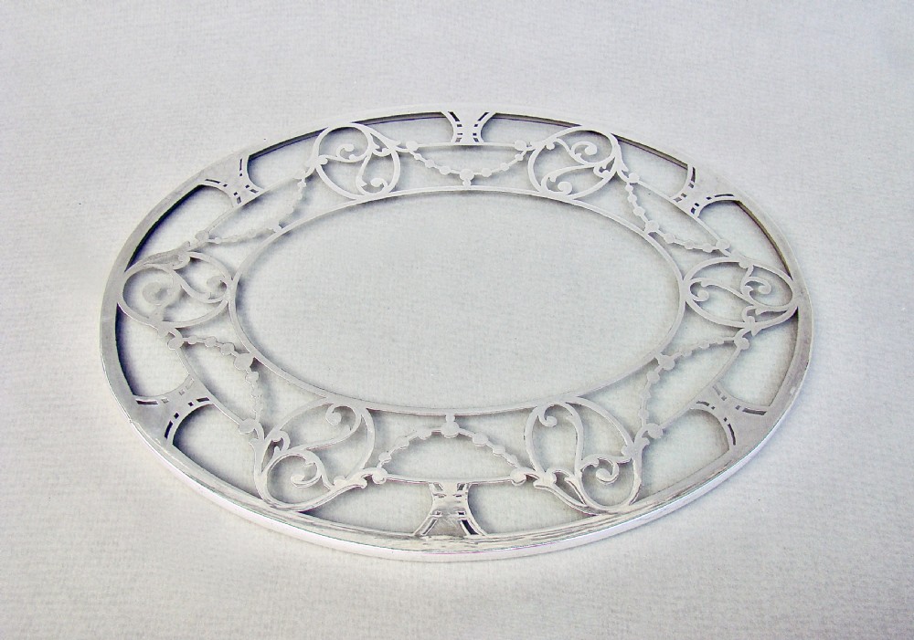 UNUSUAL SILVER MOUNTED OVAL GLASS TEAPOT STAND, CIRCA 1930
