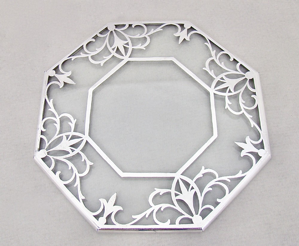 UNUSUAL OCTAGONAL SILVER MOUNTED OVAL GLASS TEAPOT STAND, CIRCA 1930