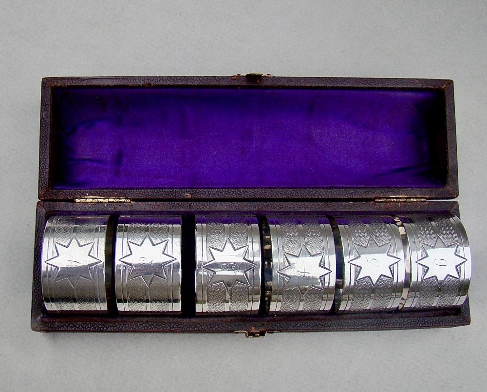 CASED SET OF SIX VICTORIAN SILVER PLATED NUMBERED NAPKIN RINGS, CIRCA 1890