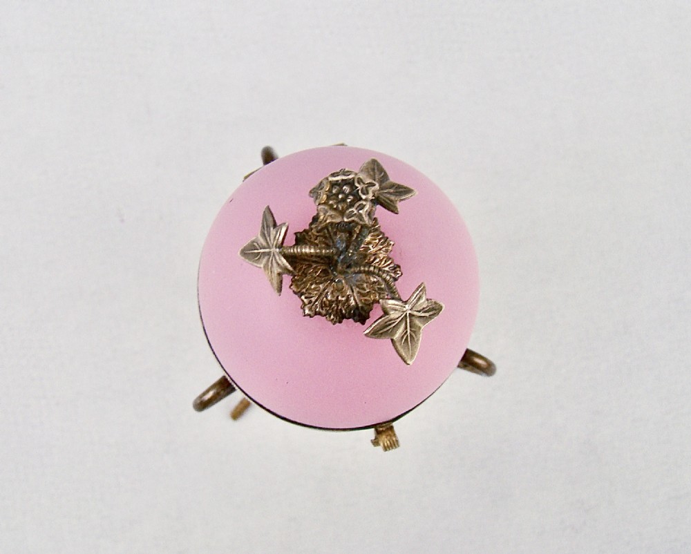 A pink opaline glass egg-shaped casket with hinged gilt metal mounts resting on an ormolu tripod stand. View IV