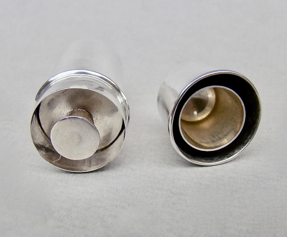 A disassembled 1913 sterling silver sewing compendium showing the cylindrical case, tiered thread spool holder, cap lid, and textured thimble. View IV