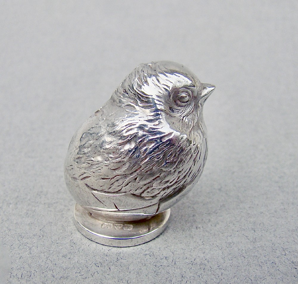 An Edwardian sterling silver desk wax seal cast in the form of a hatching chick emerging from an egg shell.