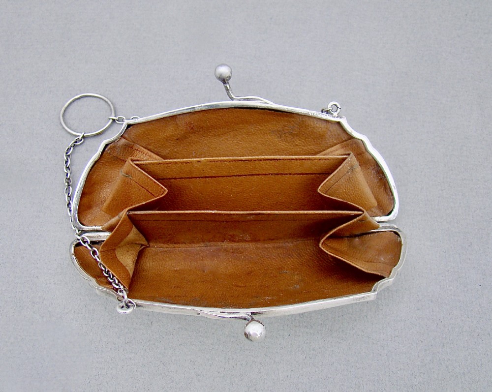 A George V sterling silver cocktail purse with engine-turned linear decoration, a central circular cartouche, a ball clasp, and a fine silver chain handle. View III