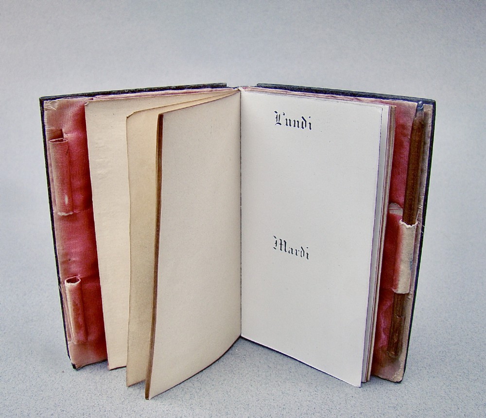 A rectangular 19th-century French tortoiseshell aide-memoire featuring floral silver inlay corner spandrels and a central engraved silver cartouche. View V