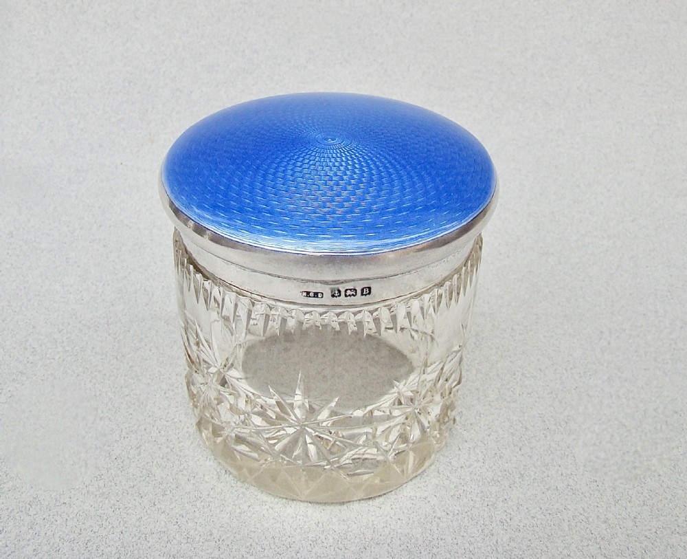 Art Deco cut glass dressing table jar featuring a bright blue guilloche enamel lid with sterling silver hallmarks.
