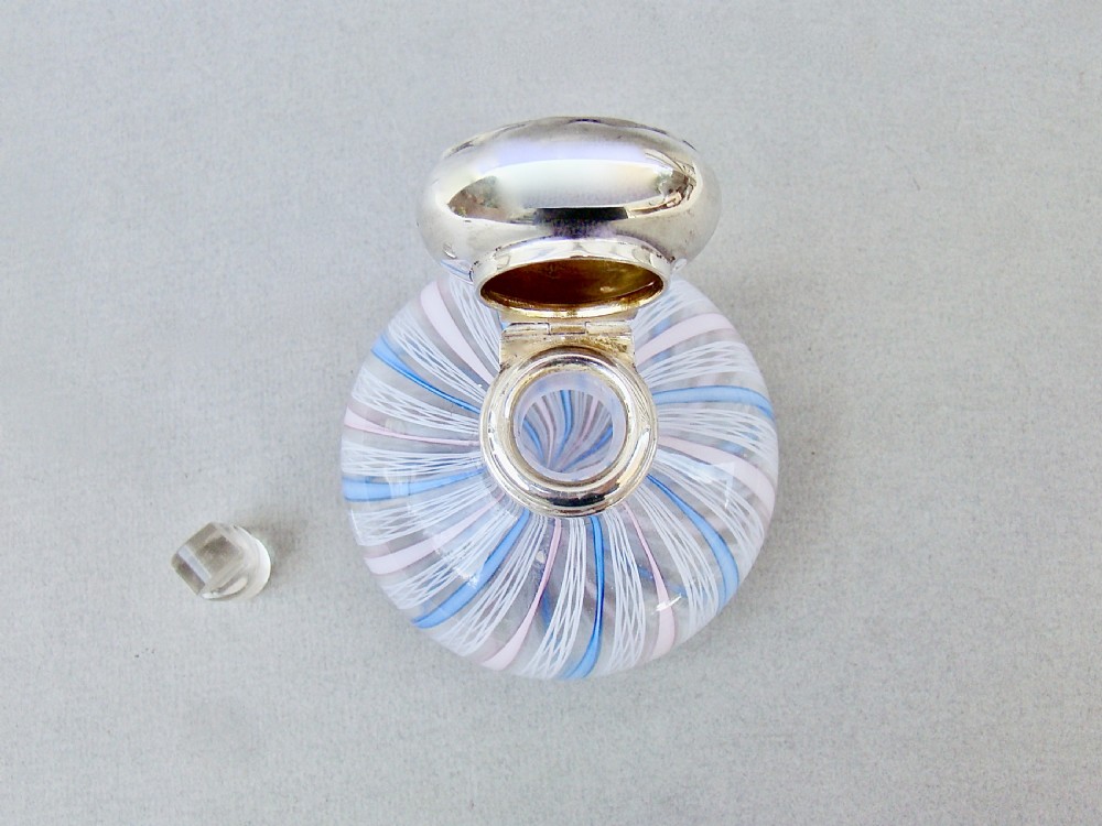 An Edwardian squat glass scent bottle featuring blue, white, and pink latticino stripes topped with a polished silver cap. View VI