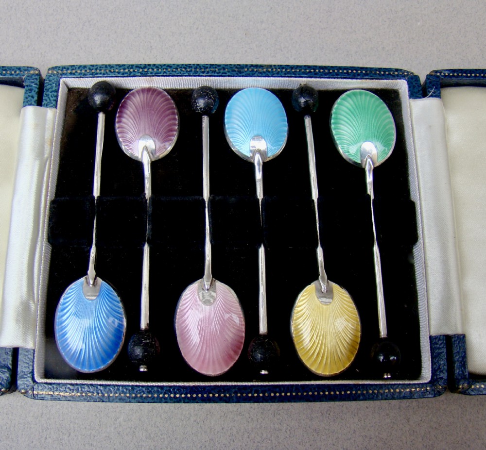 A cased set of six sterling silver coffee spoons featuring bean knops and engine-turned guilloche enamel bowls in various pastel colours. View II
