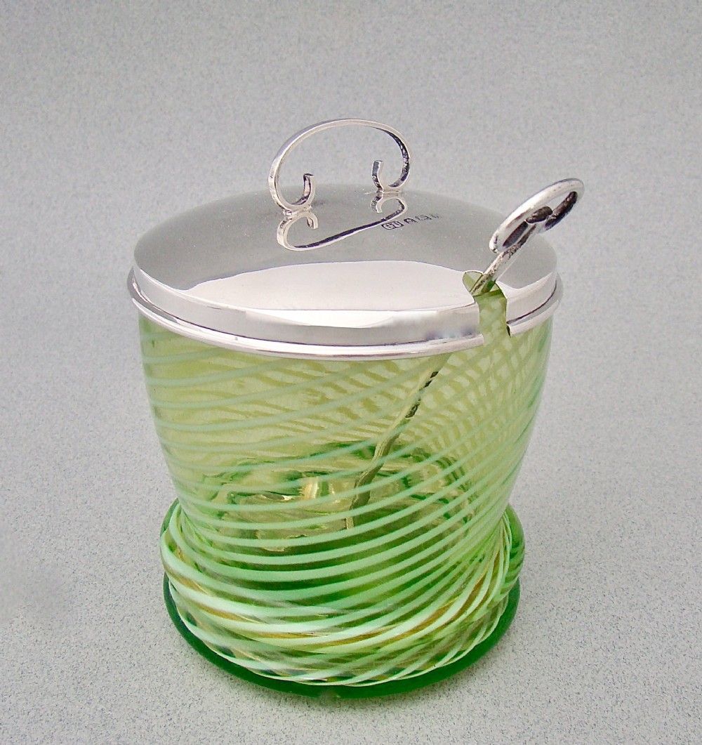 A green spiral-patterned vaseline glass preserve pot with a polished hallmarked silver lid and matching silver spoon. View III