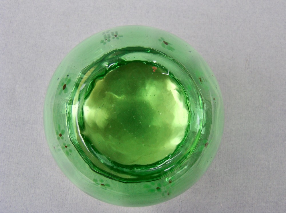 A small green glass jar decorated with white enamel flowers and topped with a hallmarked sterling silver cap. View IV