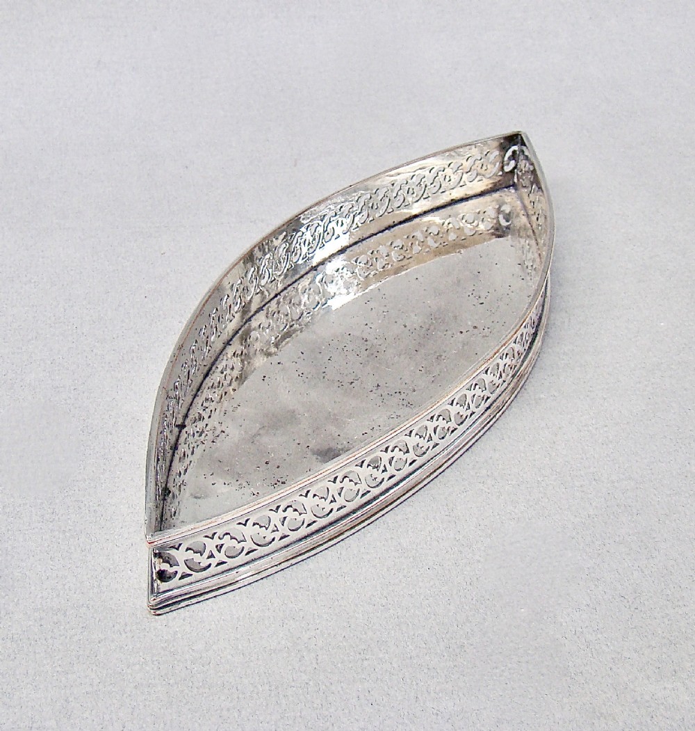 A boat-shaped Georgian Old Sheffield plate snuffer tray featuring a pierced lattice gallery rim. View IV