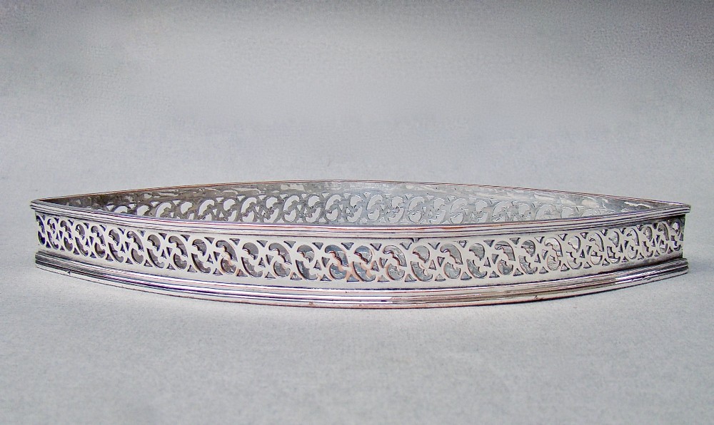 A boat-shaped Georgian Old Sheffield plate snuffer tray featuring a pierced lattice gallery rim. View V