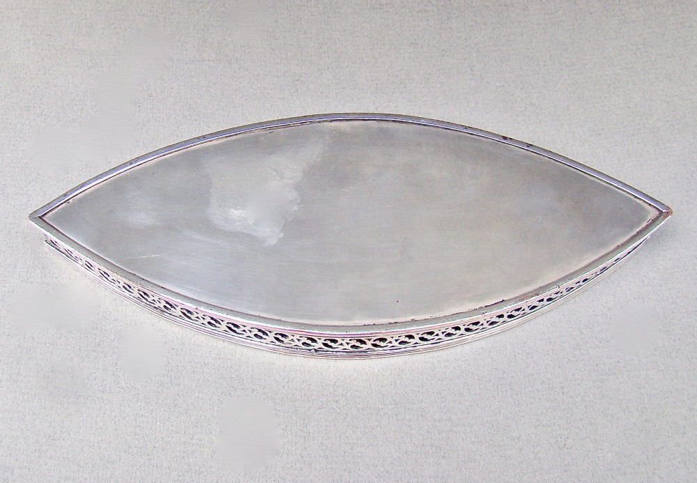 A boat-shaped Georgian Old Sheffield plate snuffer tray featuring a pierced lattice gallery rim. View VII