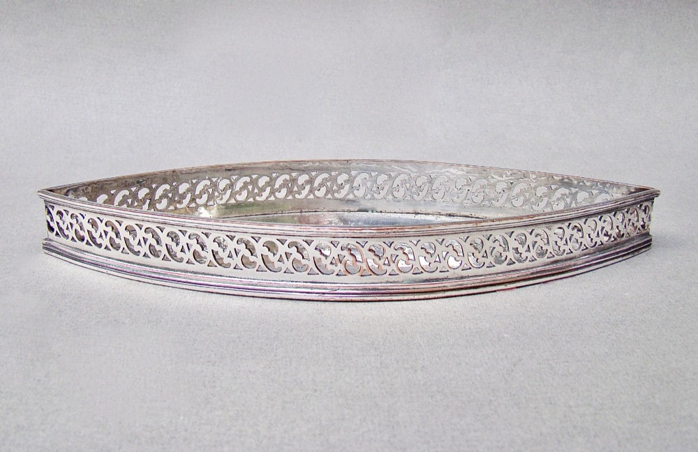A boat-shaped Georgian Old Sheffield plate snuffer tray featuring a pierced lattice gallery rim. View VIII