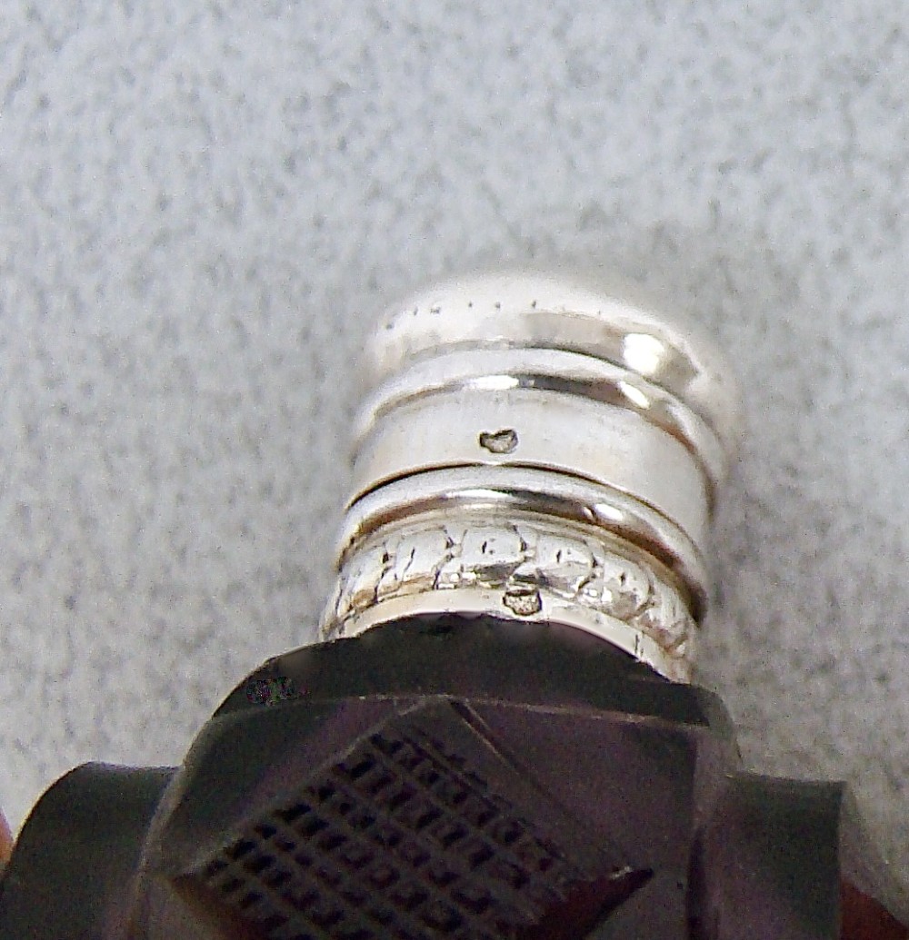 A miniature barrel-shaped purple amethyst cut glass scent bottle with a silver cap and collar. View VI