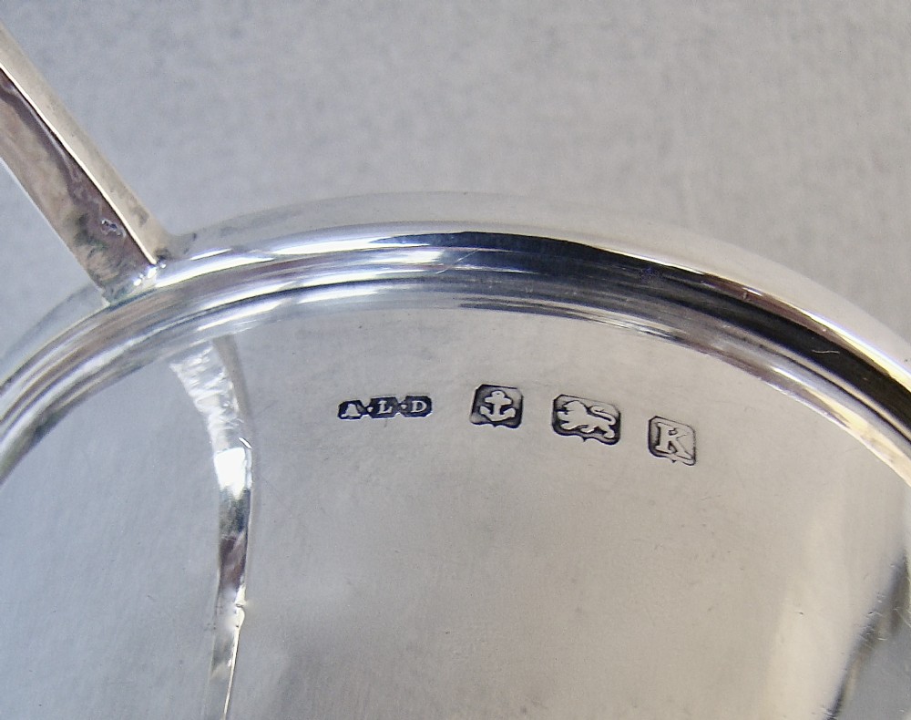 A sterling silver Art Deco christening mug with a flared body, geometric angular handle, and stepped pedestal base. View IV