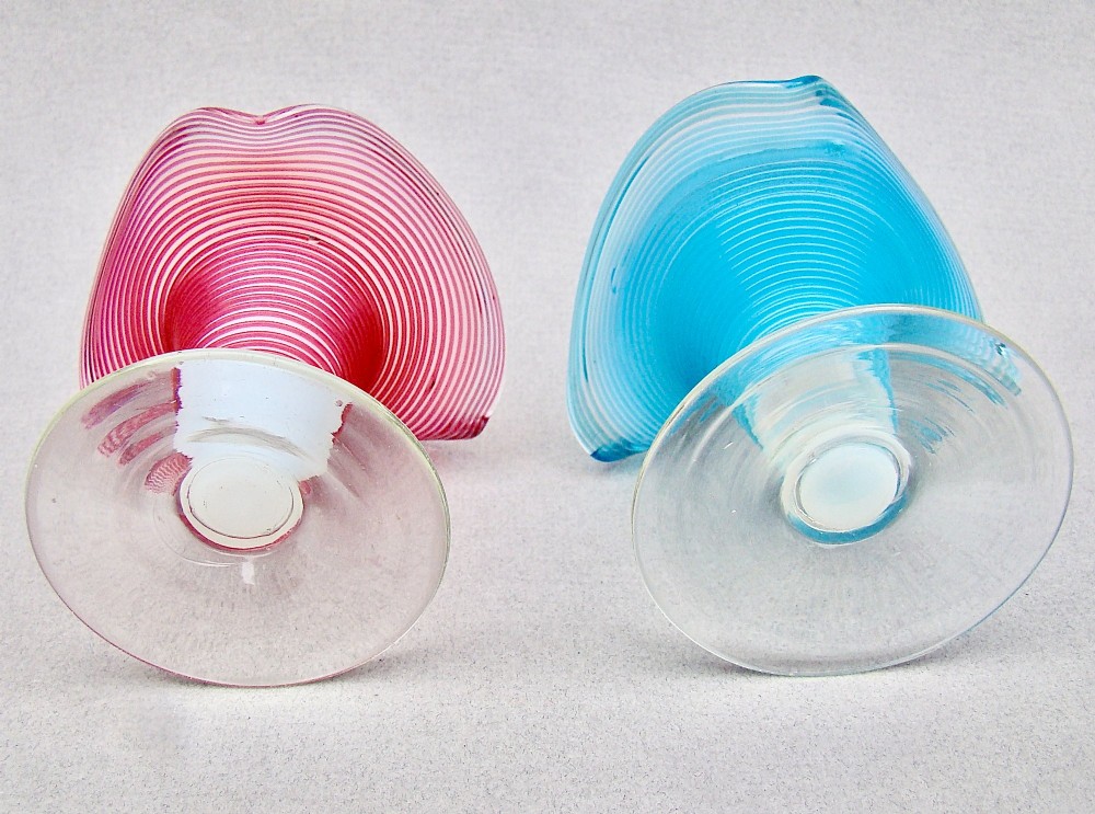 A pair of late Victorian opaline glass candlesticks with coiled threaded bodies and wide frilled rims, one in pink and one in turquoise blue. View VI