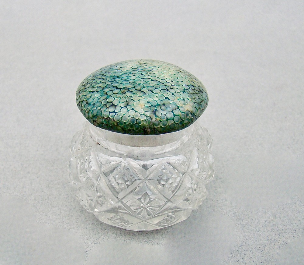 An Art Deco cut glass rouge pot with a hallmarked silver collar and a domed green shagreen lid. View II