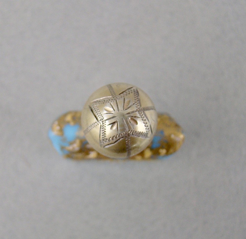 A small rectangular turquoise glass scent bottle featuring intricate gold scrollwork, white beaded enamel, and an engraved silver-gilt cap. View VII
