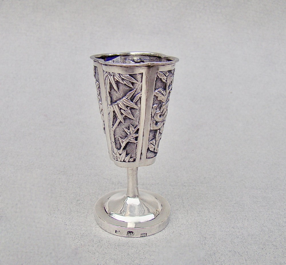 A 19th-century Chinese export silver toothpick holder featuring repousse bamboo motifs on a pedestal base with maker hallmarks stamped on the foot rim.