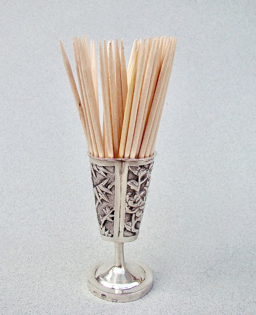 A 19th-century Chinese export silver toothpick holder featuring repousse bamboo motifs on a pedestal base with maker hallmarks stamped on the foot rim. View II