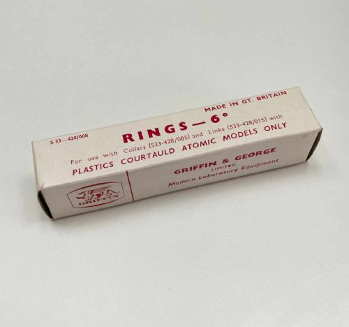 fig 6. A vintage wooden case filled with colourful plastic atomic model components, accompanied by an instructional booklet and a printed chart inside the lid.