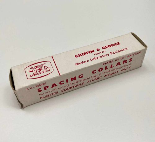 fig 7. A vintage wooden case filled with colourful plastic atomic model components, accompanied by an instructional booklet and a printed chart inside the lid.