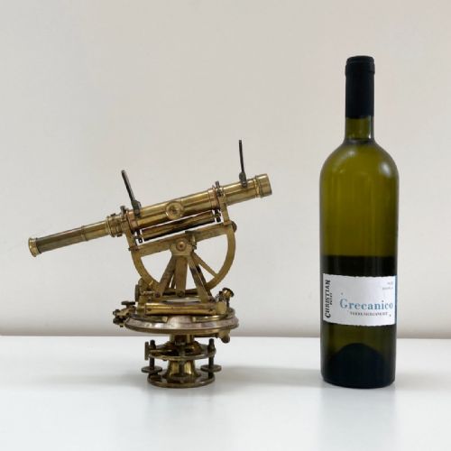 fig 1. A William IV miniature brass altazimuth theodolite featuring a central sighting telescope, vertical semicircular scale, horizontal vernier plate, and levelling screws.