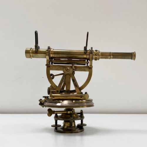 fig 2. A William IV miniature brass altazimuth theodolite featuring a central sighting telescope, vertical semicircular scale, horizontal vernier plate, and levelling screws.