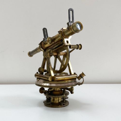 fig 3. A William IV miniature brass altazimuth theodolite featuring a central sighting telescope, vertical semicircular scale, horizontal vernier plate, and levelling screws.