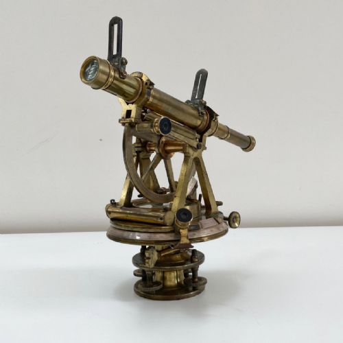 fig 4. A William IV miniature brass altazimuth theodolite featuring a central sighting telescope, vertical semicircular scale, horizontal vernier plate, and levelling screws.