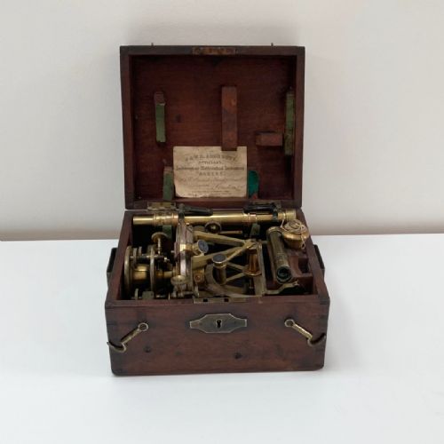 fig 6. A William IV miniature brass altazimuth theodolite featuring a central sighting telescope, vertical semicircular scale, horizontal vernier plate, and levelling screws.