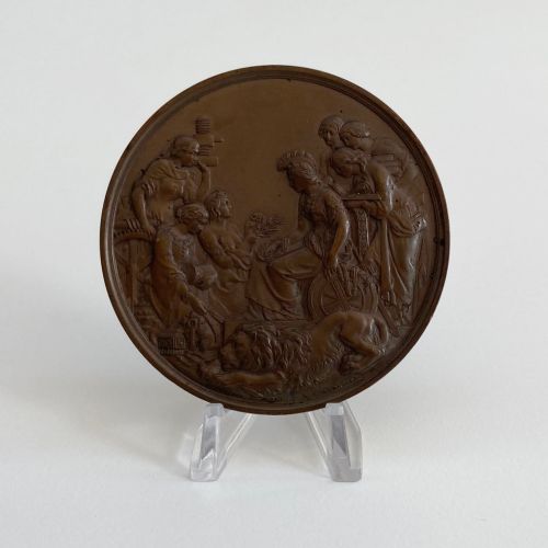 fig 5. An antique 1862 London International Exhibition bronze medal resting inside its original opened maroon presentation case with blue velvet lining.