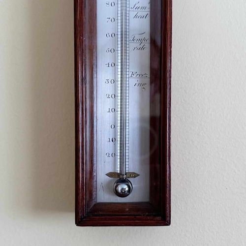 fig 2. A vertical George III mahogany cased wall thermometer featuring a glazed front, silvered register scale, and top hanging loop.