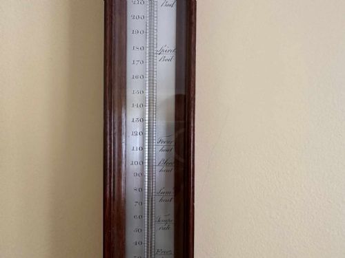 fig 4. A vertical George III mahogany cased wall thermometer featuring a glazed front, silvered register scale, and top hanging loop.