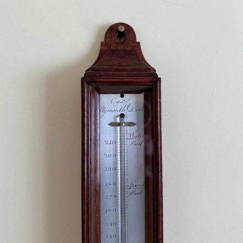 fig 5. A vertical George III mahogany cased wall thermometer featuring a glazed front, silvered register scale, and top hanging loop.
