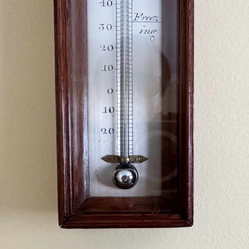 fig 7. A vertical George III mahogany cased wall thermometer featuring a glazed front, silvered register scale, and top hanging loop.