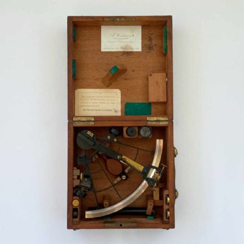 fig 3. An antique French marine navigation set displayed in three open fitted mahogany cases containing a brass sextant, telescopes, and optical filters.