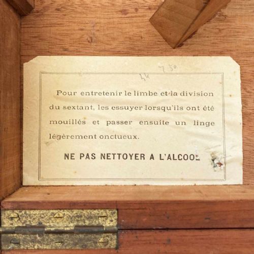 fig 4. An antique French marine navigation set displayed in three open fitted mahogany cases containing a brass sextant, telescopes, and optical filters.