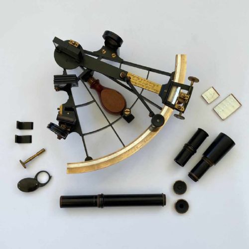 fig 6. An antique French marine navigation set displayed in three open fitted mahogany cases containing a brass sextant, telescopes, and optical filters.