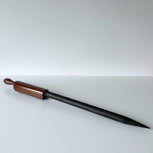 fig 1. A Victorian hotbed soil thermometer featuring a long black pointed iron spike attached to a dark wooden housing with a open hinged protective lid revealing a glass scale.