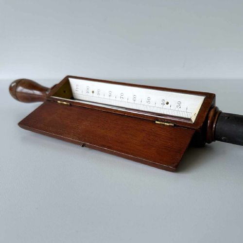 fig 4. A Victorian hotbed soil thermometer featuring a long black pointed iron spike attached to a dark wooden housing with a open hinged protective lid revealing a glass scale.