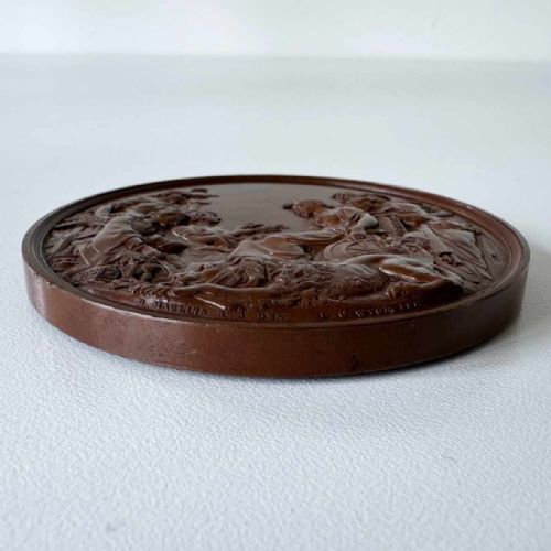 fig 6. A circular Victorian bronze exhibition medallion depicting classical allegorical figures, Britannia, and a reclining lion in high relief.