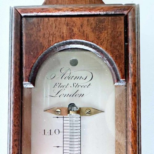 fig 1. An 18th-century vertical mahogany cased wall thermometer with an engraved scale plate and glass capillary tube.