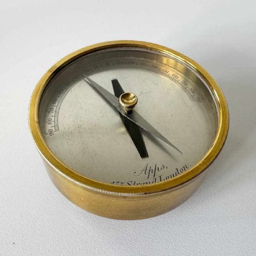 fig 3. A Victorian brass pocket galvanometer with a silvered dial housed inside a open dark leather protective case lined with blue velvet.