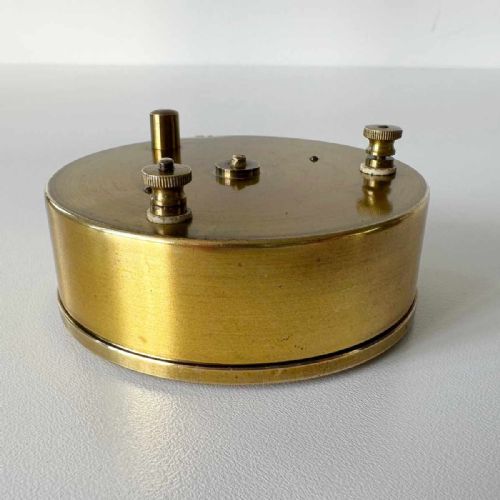 fig 7. A Victorian brass pocket galvanometer with a silvered dial housed inside a open dark leather protective case lined with blue velvet.